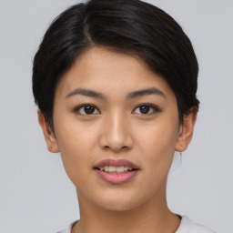 Joyful asian young-adult female with short  black hair and brown eyes