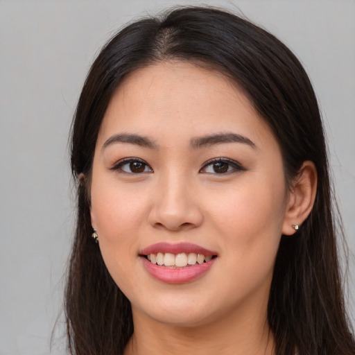 Joyful asian young-adult female with long  brown hair and brown eyes