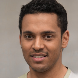 Joyful white young-adult male with short  black hair and brown eyes