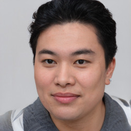 Joyful asian young-adult male with short  brown hair and brown eyes