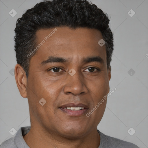 Joyful black adult male with short  brown hair and brown eyes