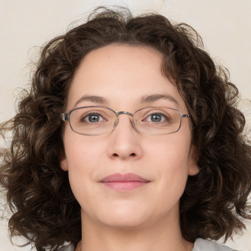 Joyful white adult female with medium  brown hair and green eyes