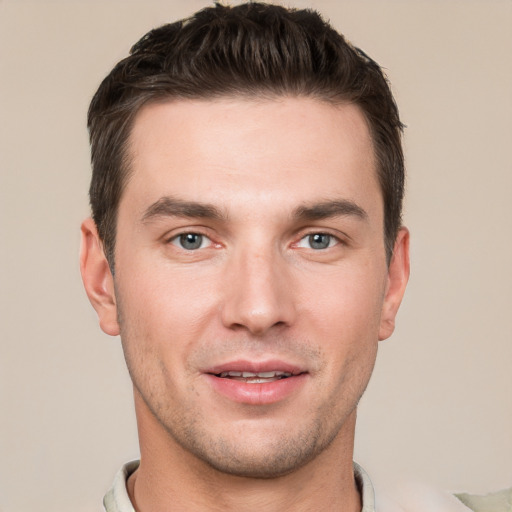 Joyful white young-adult male with short  brown hair and grey eyes