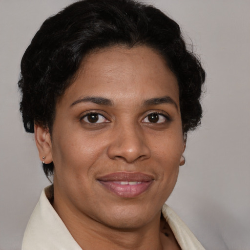 Joyful latino adult female with short  brown hair and brown eyes