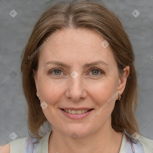 Joyful white adult female with medium  brown hair and blue eyes