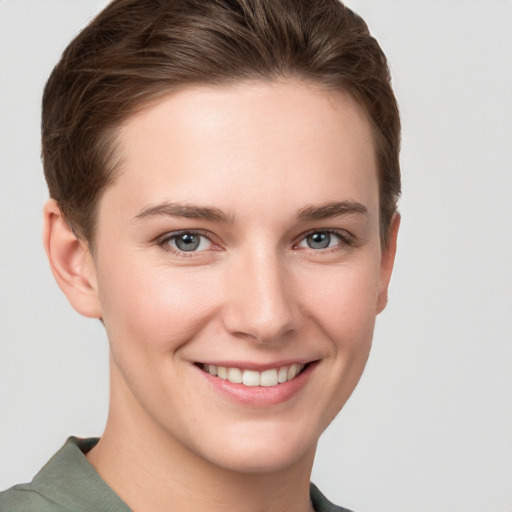 Joyful white young-adult female with short  brown hair and grey eyes