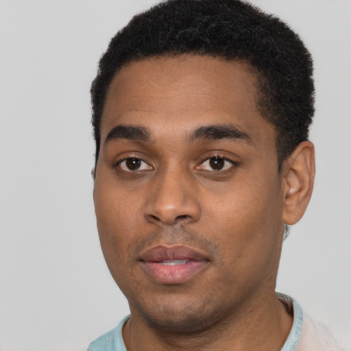 Joyful black young-adult male with short  black hair and brown eyes