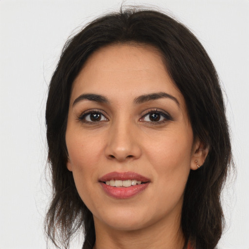 Joyful white young-adult female with long  brown hair and brown eyes