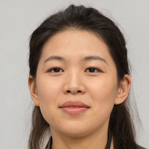 Joyful asian young-adult female with long  brown hair and brown eyes