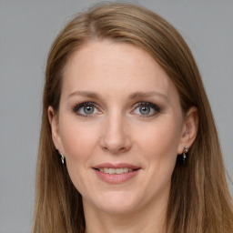 Joyful white young-adult female with long  brown hair and grey eyes