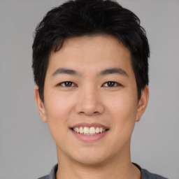 Joyful asian young-adult male with short  black hair and brown eyes