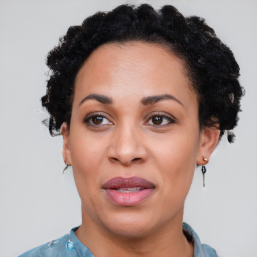 Joyful black adult female with short  black hair and brown eyes