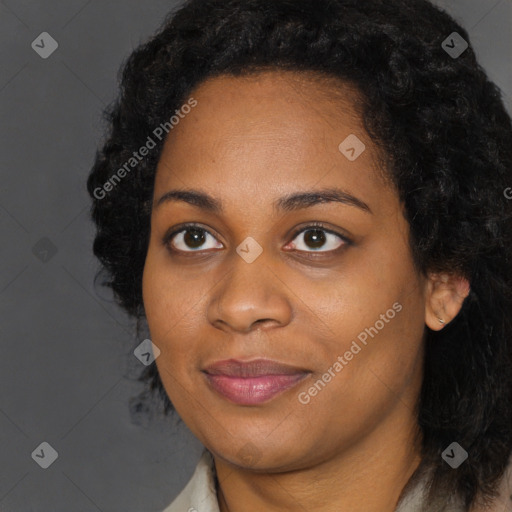 Joyful black young-adult female with long  black hair and brown eyes