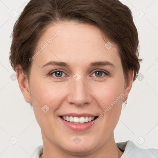 Joyful white young-adult female with short  brown hair and grey eyes