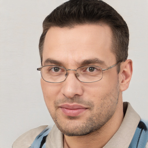 Joyful white adult male with short  brown hair and brown eyes