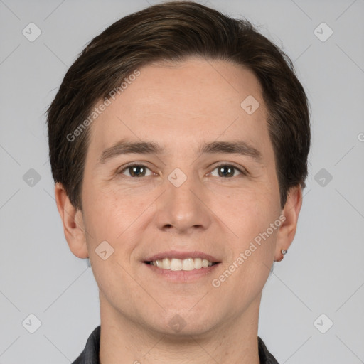 Joyful white young-adult male with short  brown hair and grey eyes