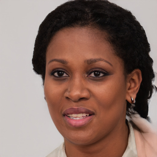 Joyful black young-adult female with short  brown hair and brown eyes