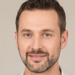 Joyful white adult male with short  brown hair and brown eyes