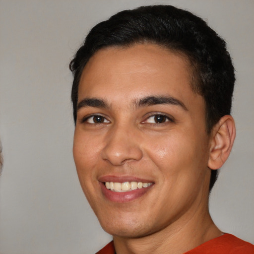 Joyful white young-adult male with short  black hair and brown eyes