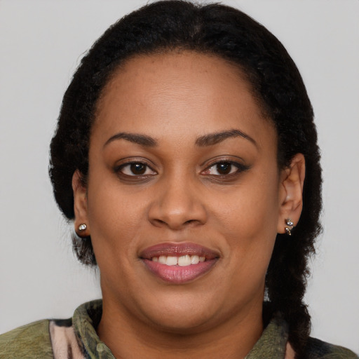 Joyful black young-adult female with medium  brown hair and brown eyes