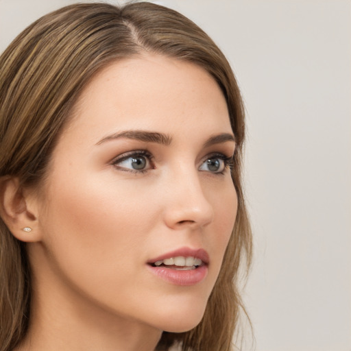 Neutral white young-adult female with long  brown hair and green eyes