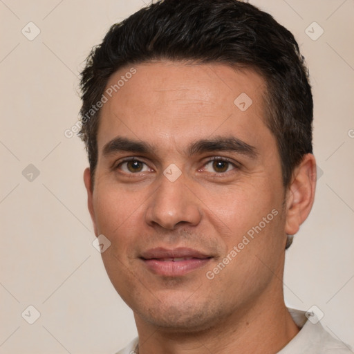 Joyful white young-adult male with short  black hair and brown eyes