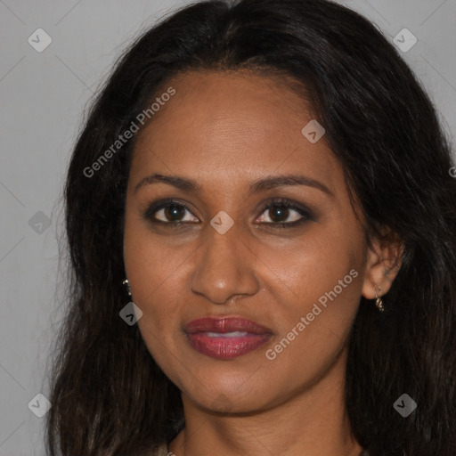 Joyful black young-adult female with long  brown hair and brown eyes