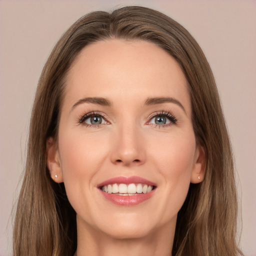 Joyful white young-adult female with long  brown hair and brown eyes