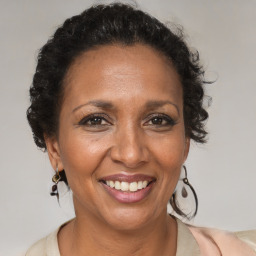 Joyful black adult female with medium  brown hair and brown eyes