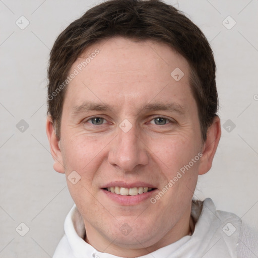 Joyful white adult male with short  brown hair and grey eyes