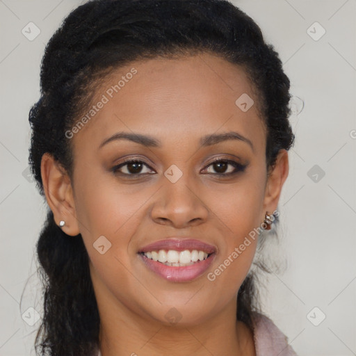 Joyful black young-adult female with long  brown hair and brown eyes