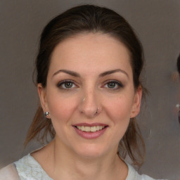 Joyful white young-adult female with medium  brown hair and brown eyes