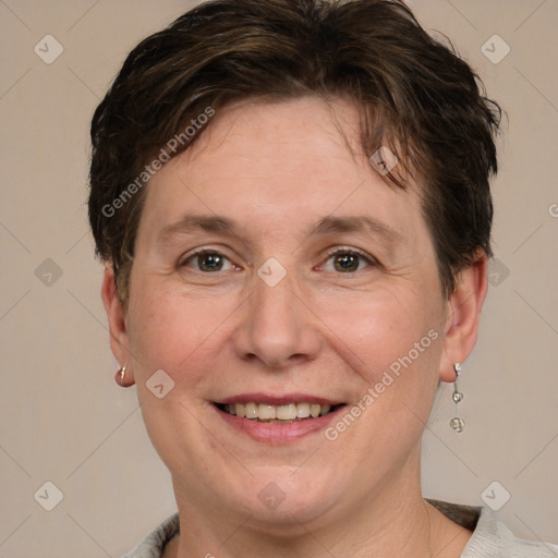 Joyful white adult female with short  brown hair and grey eyes