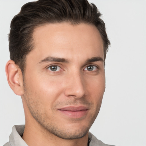 Joyful white young-adult male with short  brown hair and brown eyes