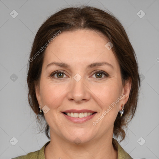 Joyful white adult female with medium  brown hair and grey eyes