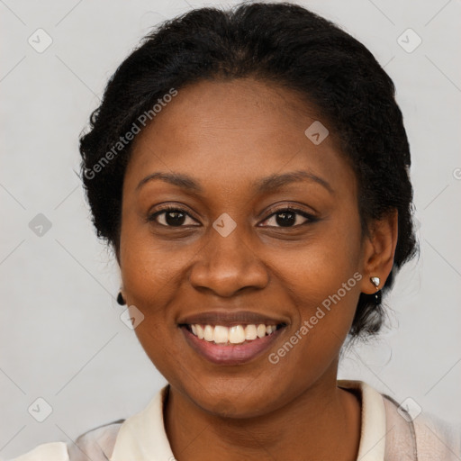 Joyful black adult female with medium  brown hair and brown eyes