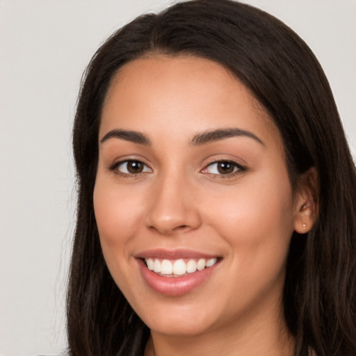 Joyful white young-adult female with long  brown hair and brown eyes