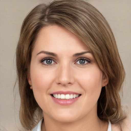 Joyful white young-adult female with medium  brown hair and green eyes