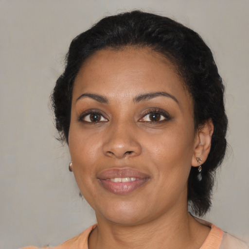 Joyful black young-adult female with medium  brown hair and brown eyes