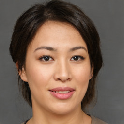 Joyful asian young-adult female with medium  brown hair and brown eyes