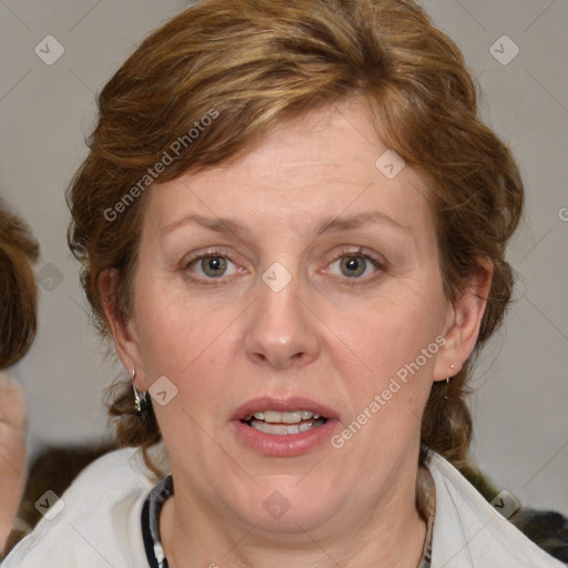 Joyful white adult female with medium  brown hair and blue eyes