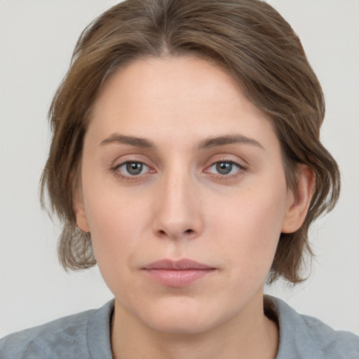 Neutral white young-adult female with medium  brown hair and grey eyes