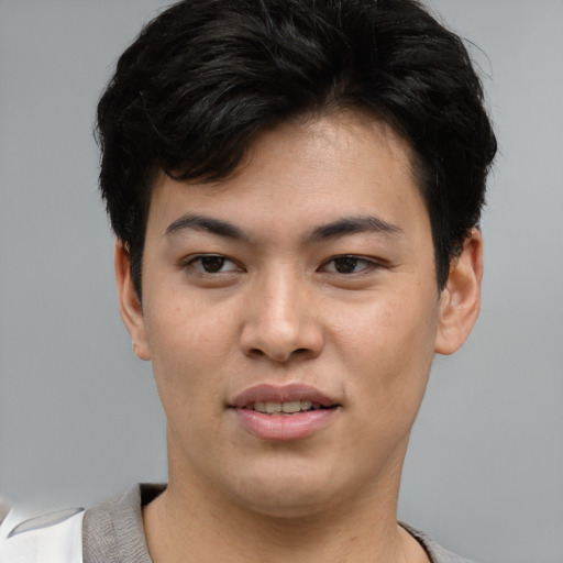 Joyful asian young-adult male with short  brown hair and brown eyes