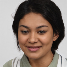 Joyful latino young-adult female with medium  black hair and brown eyes