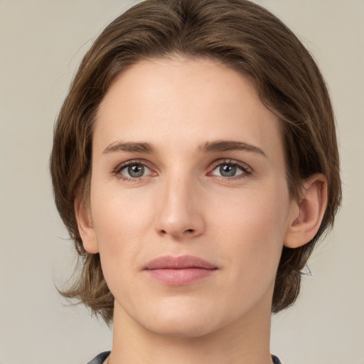 Joyful white young-adult female with medium  brown hair and green eyes