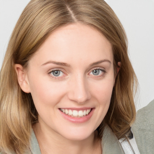 Joyful white young-adult female with medium  brown hair and blue eyes