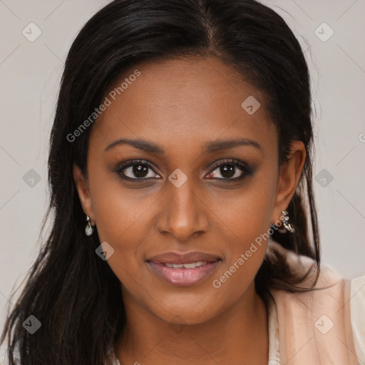 Joyful black young-adult female with long  brown hair and brown eyes