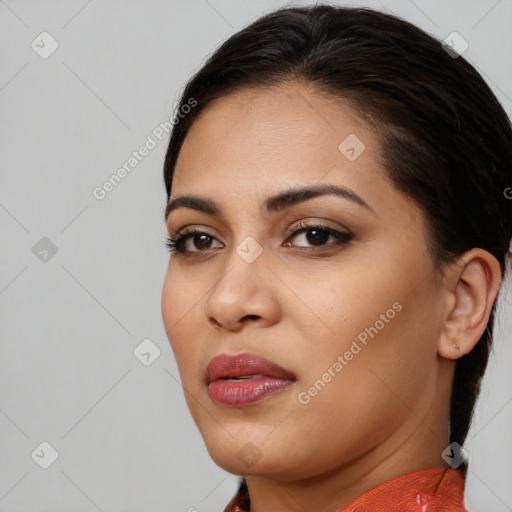 Joyful latino young-adult female with medium  brown hair and brown eyes