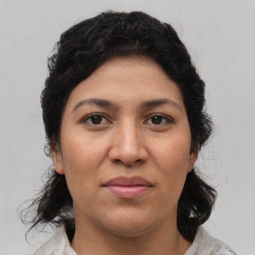 Joyful latino young-adult female with medium  black hair and brown eyes