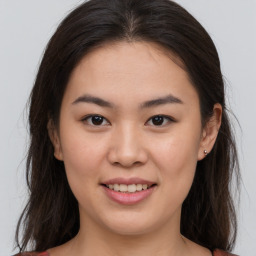 Joyful asian young-adult female with long  brown hair and brown eyes